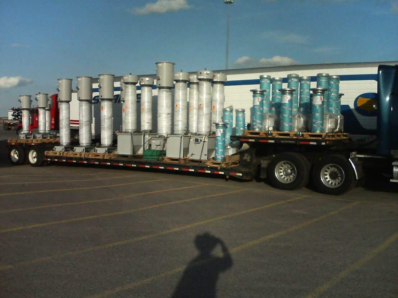 Drop-deck trailer loaded with industrial equipment ready for transport
